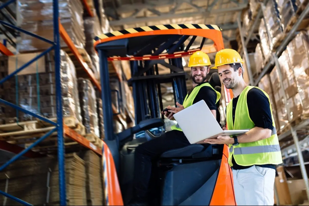 Logistikteam mit Gabelstapler in einer Lagerhalle